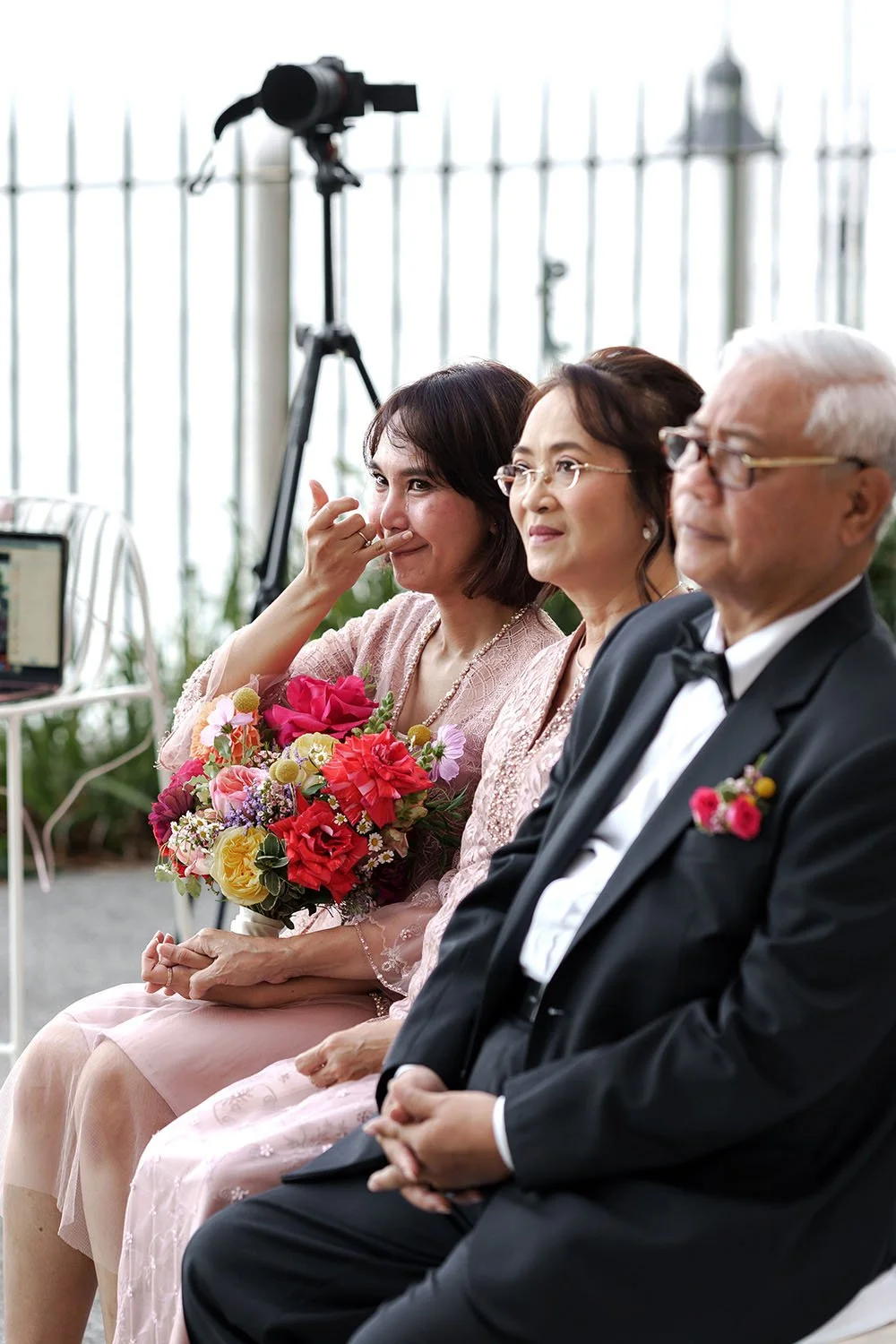 bride Nori's sister is crying and holding her mum's hand