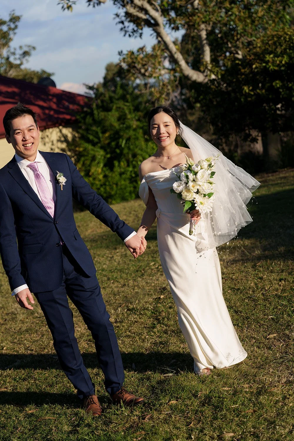 Eric and Flora holding hands look at the Brisbane wedding photographer Whistler Li