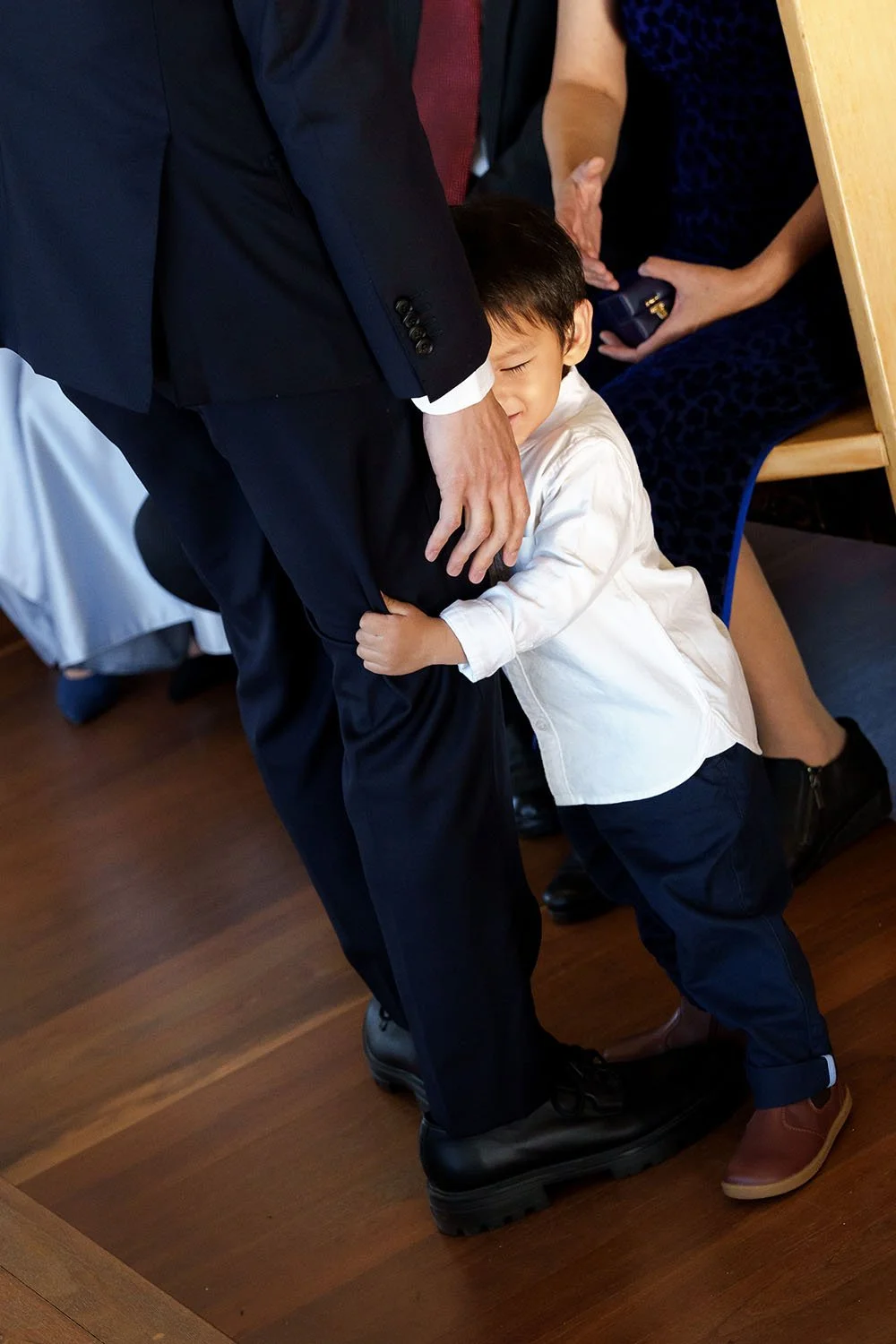 a little boy hugging Michael's leg