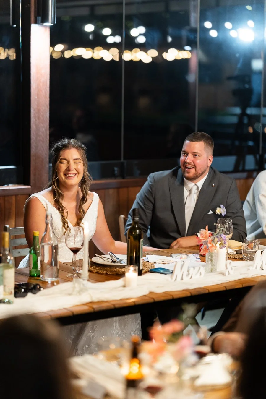 bride Chiarra laughing with eyes close and groom Ben smell too