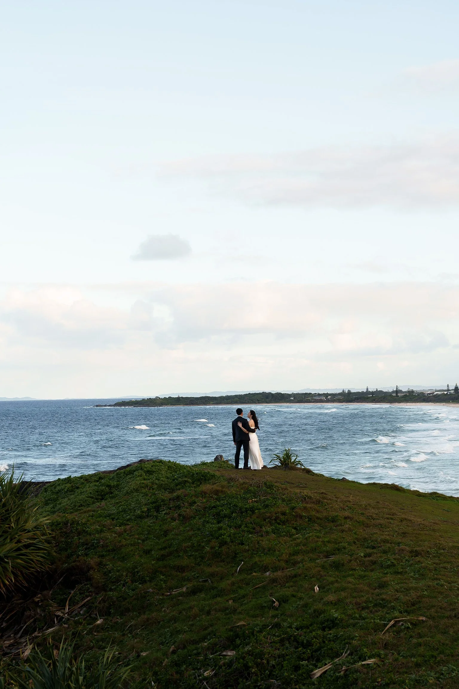 They held each other, looking out at the sea.