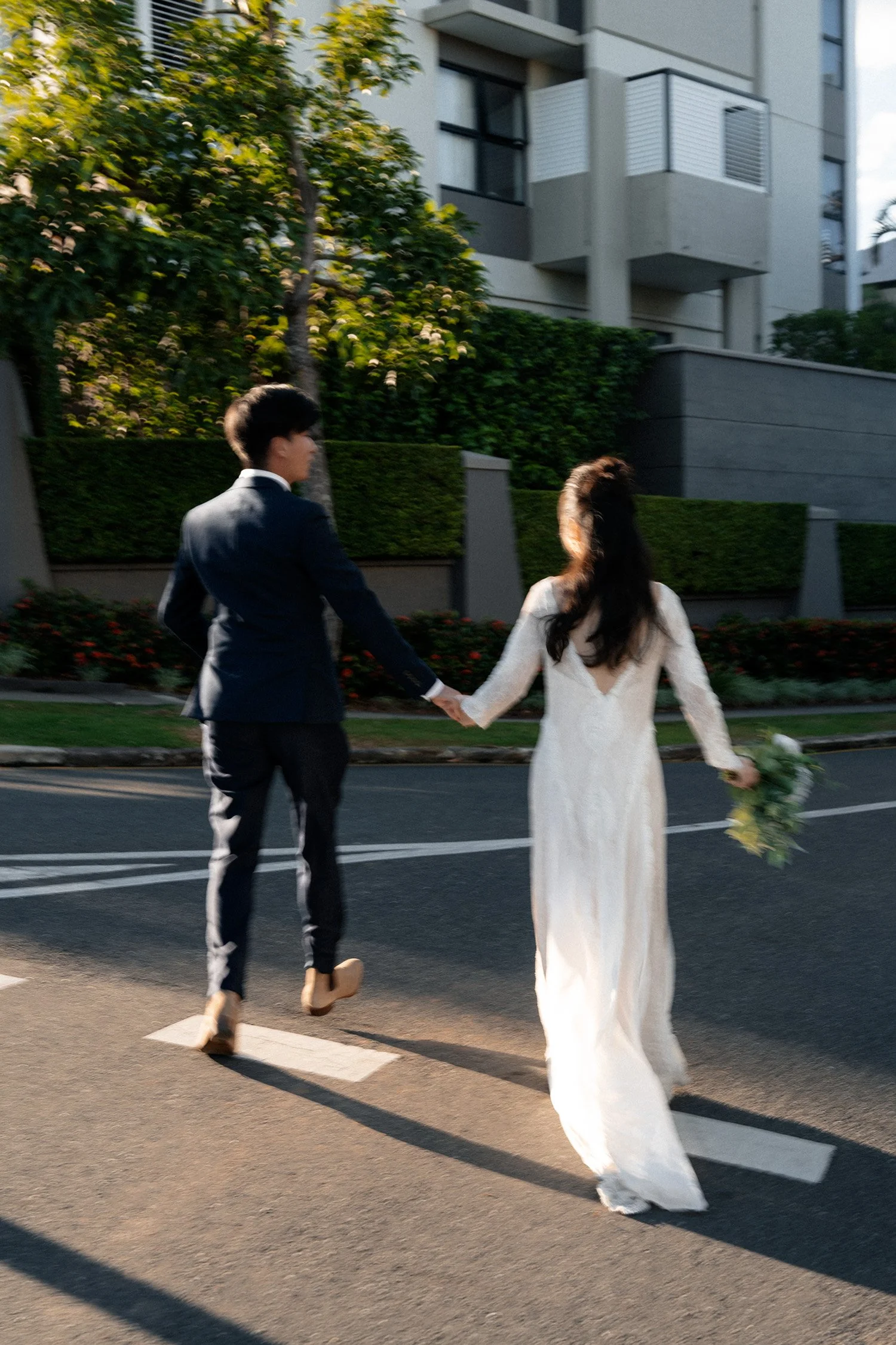 groom Leo holding bride Cassie's hand when she look at him and they running
