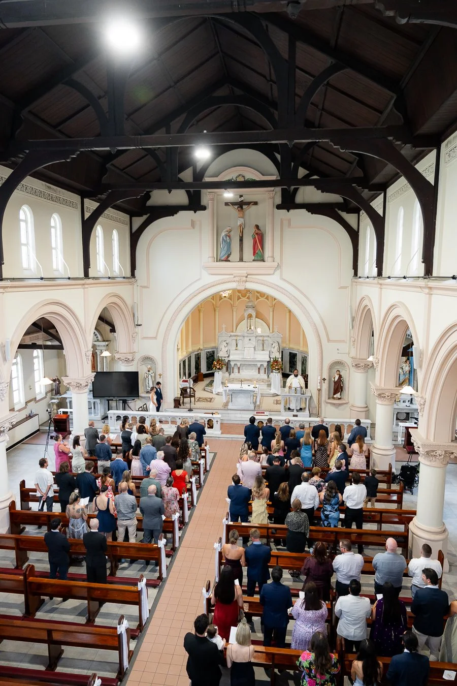 Everyone stood up, waiting for the priest to begin his ceremony in St Mary's Catholic Church