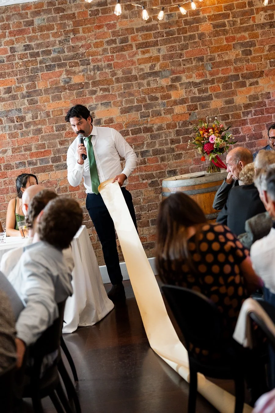 Giordan's best man have a roll of paper with his speech