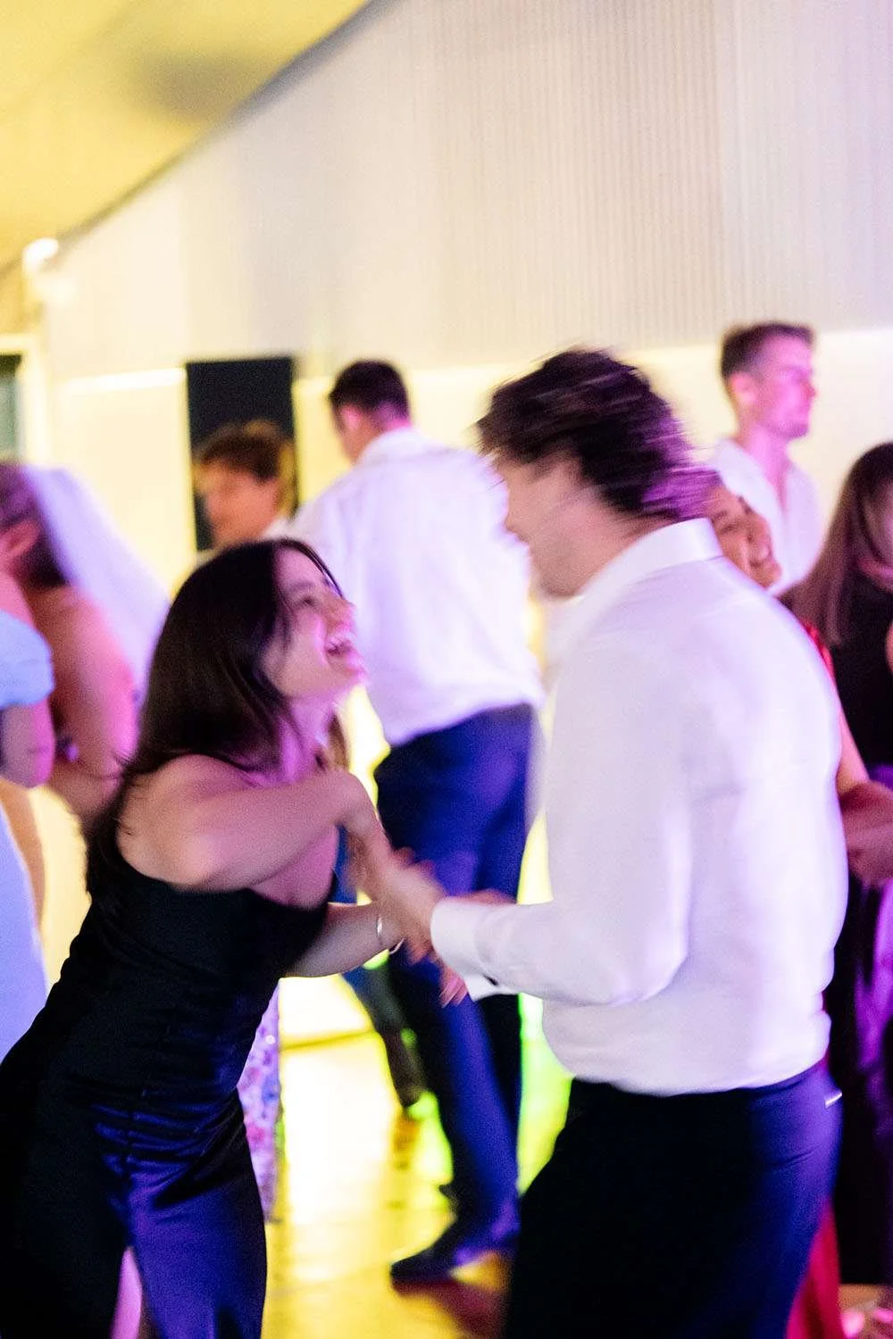 two guests dancing together while laughing at each other