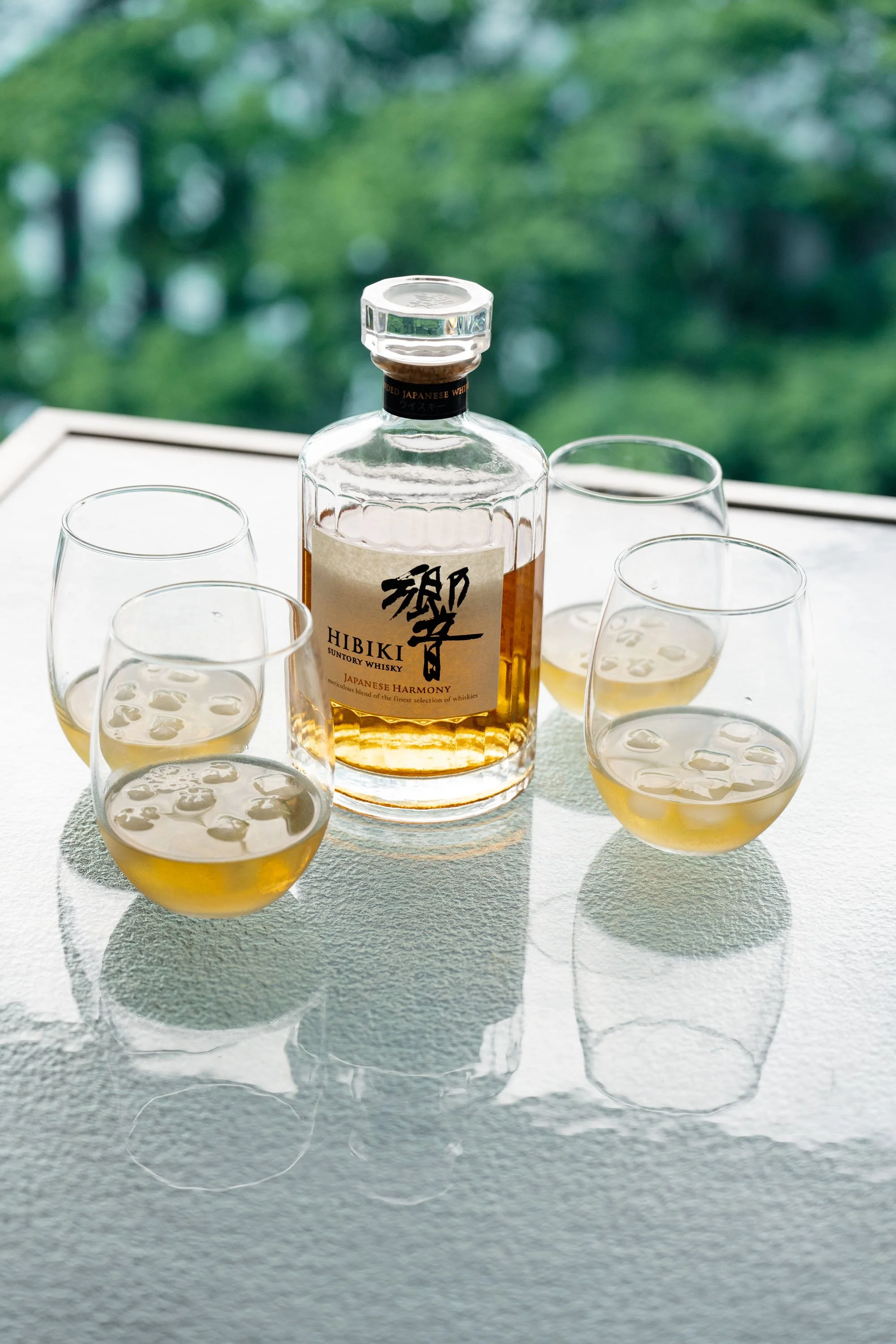 Hibiki whiskey bottle accompanied by four glasses on a table, ready for a toast during the wedding celebration