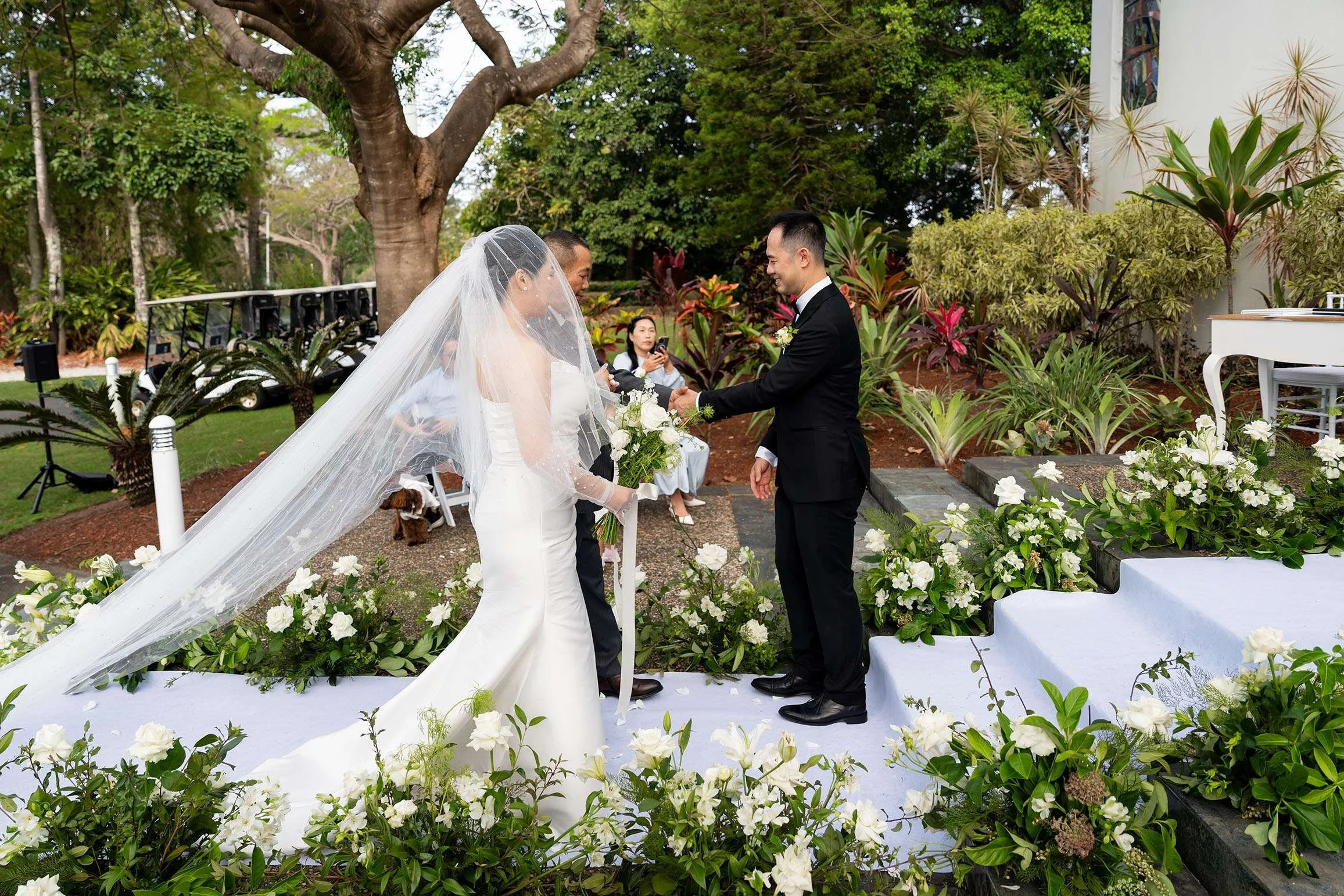 bride's father walking with her hand over to Alex