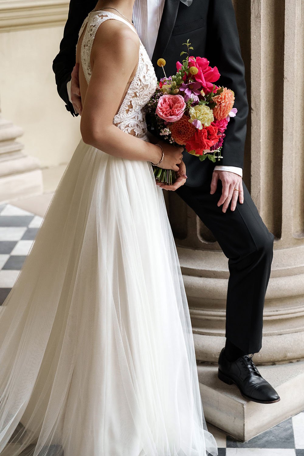 Nori's red flower and groom Cliffe's hand