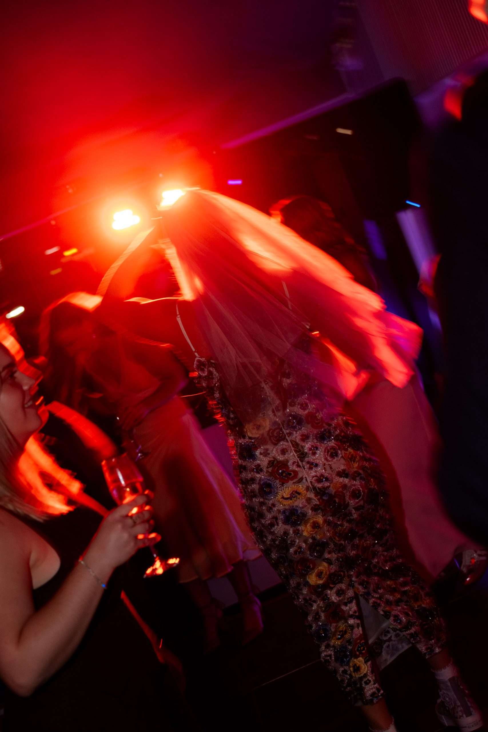 red dancing light hits bride's veil