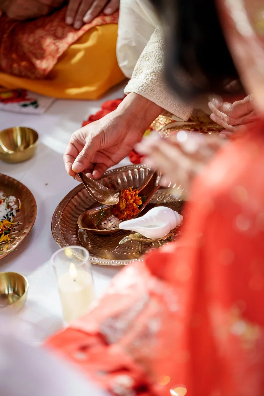 Amrita's uncle spoon an oil into another