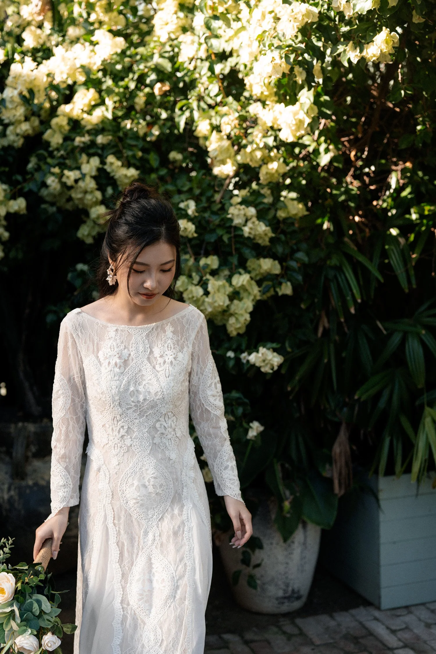 bride Cassie look down to the floor when holding a flower