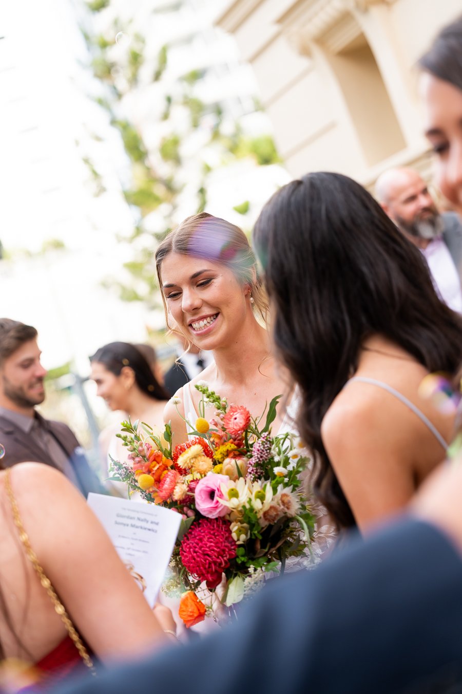 bride Sonya smell to her guests after ceremony