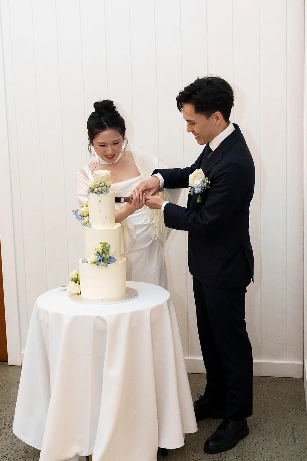 Lisa and Michael cutting the cake together
