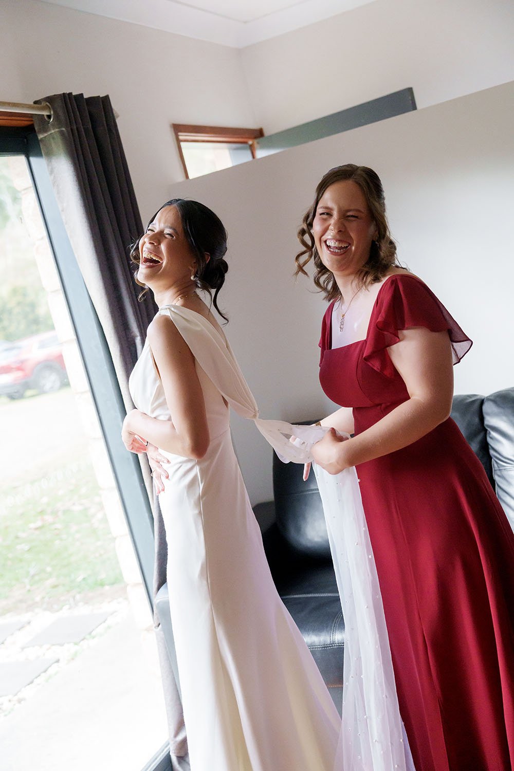 Jasmin and her maid of honour both big laughing to the Brisbane wedding photographer Whistler Li