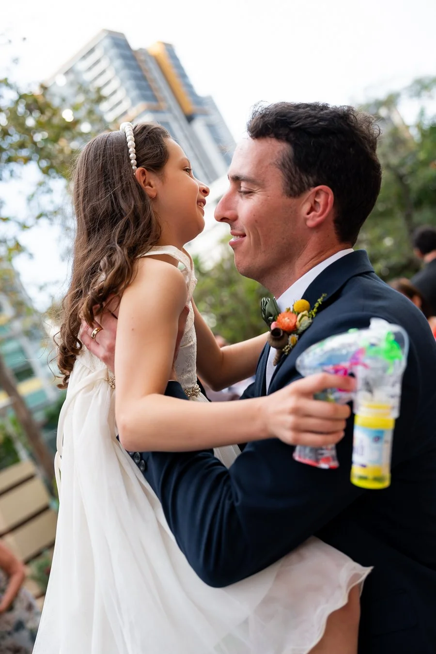 groom Giordan holding a girl up