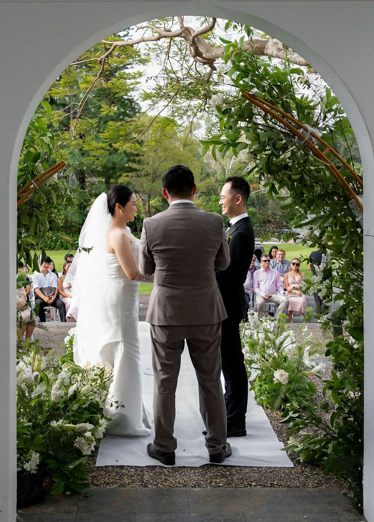 Wendy and Alex hands holding look at each other, all the guest as the background