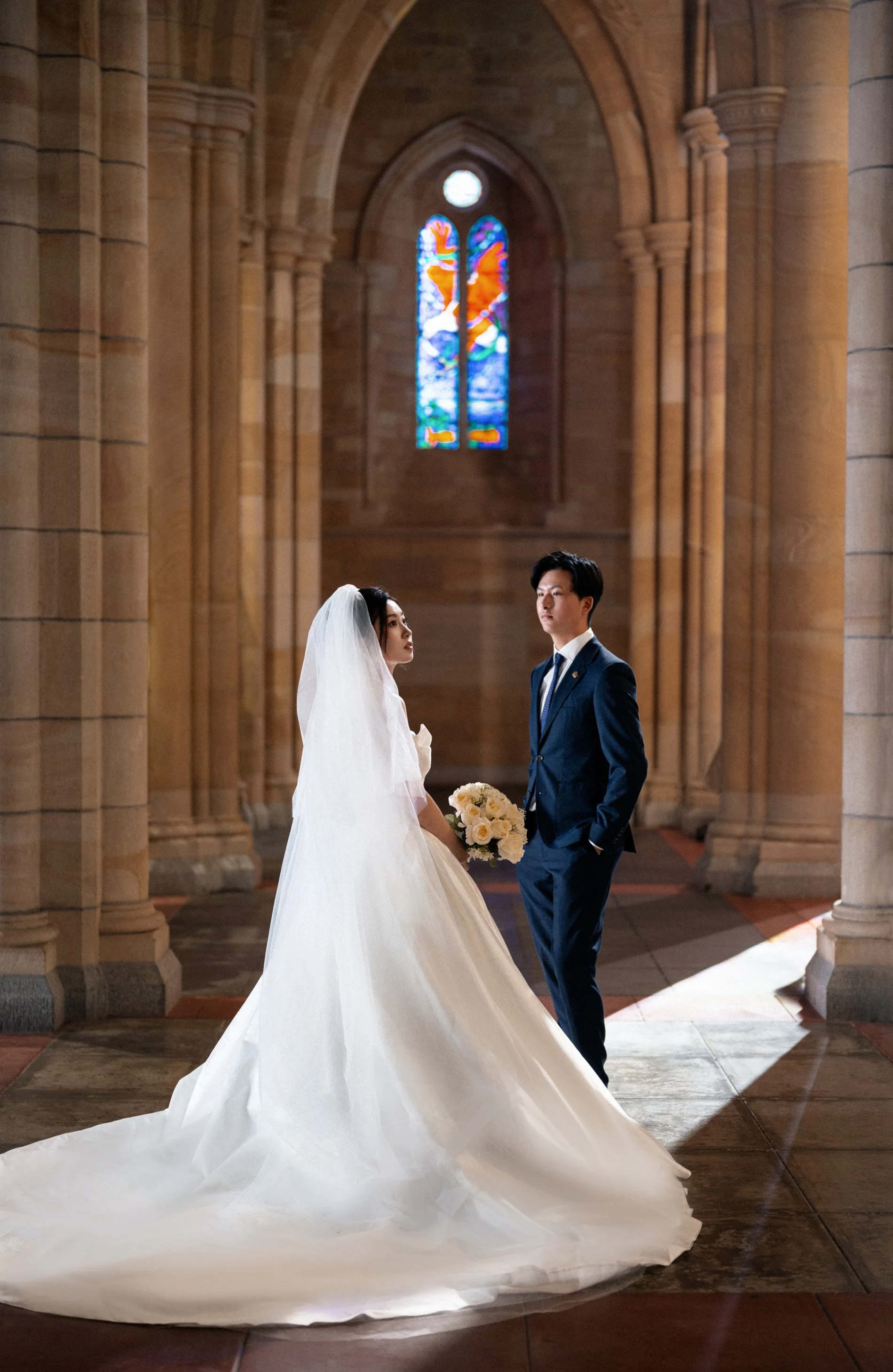 bride look to her right and groom look to her