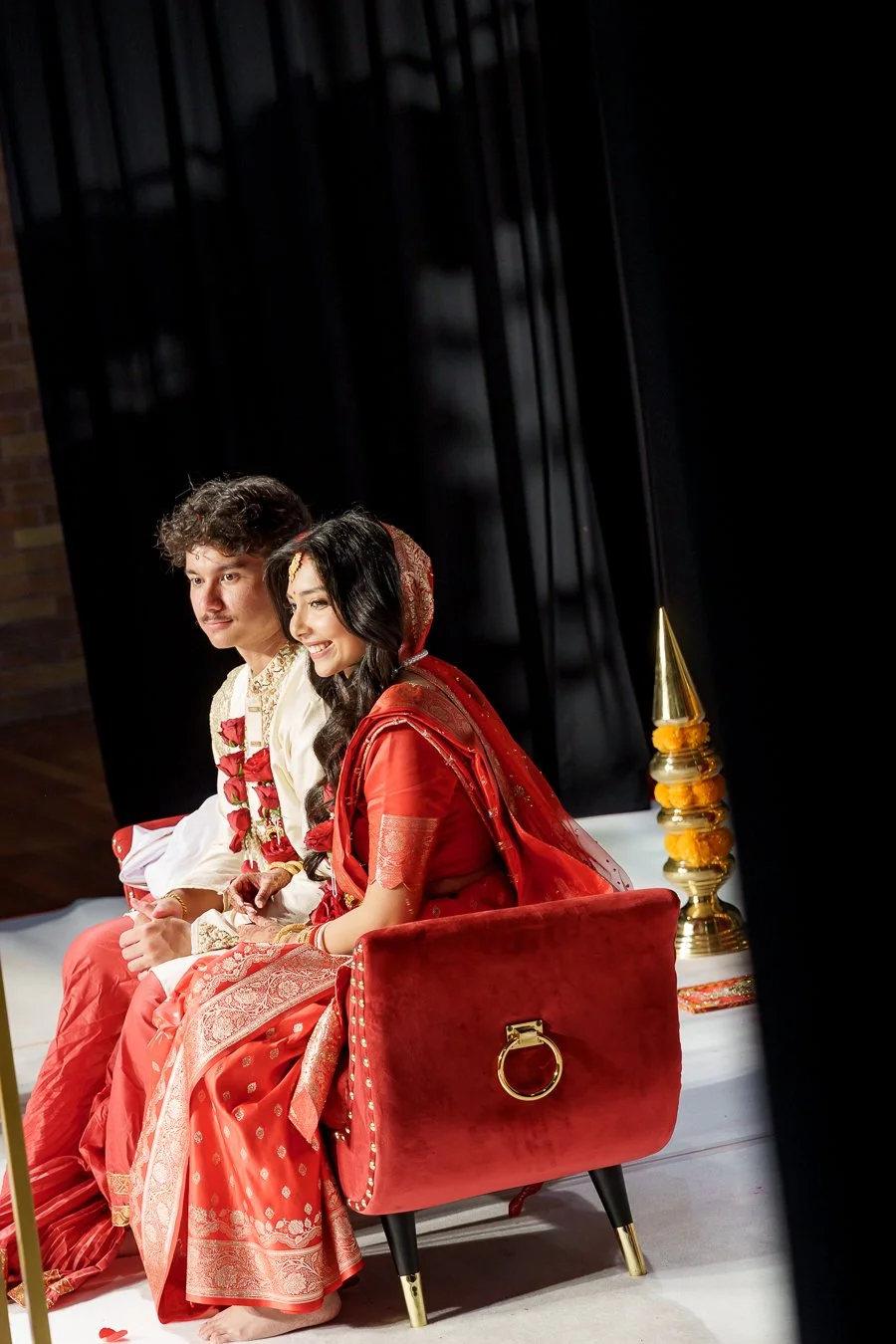 Amrita and Casey sitting next to each other look to all the guests
