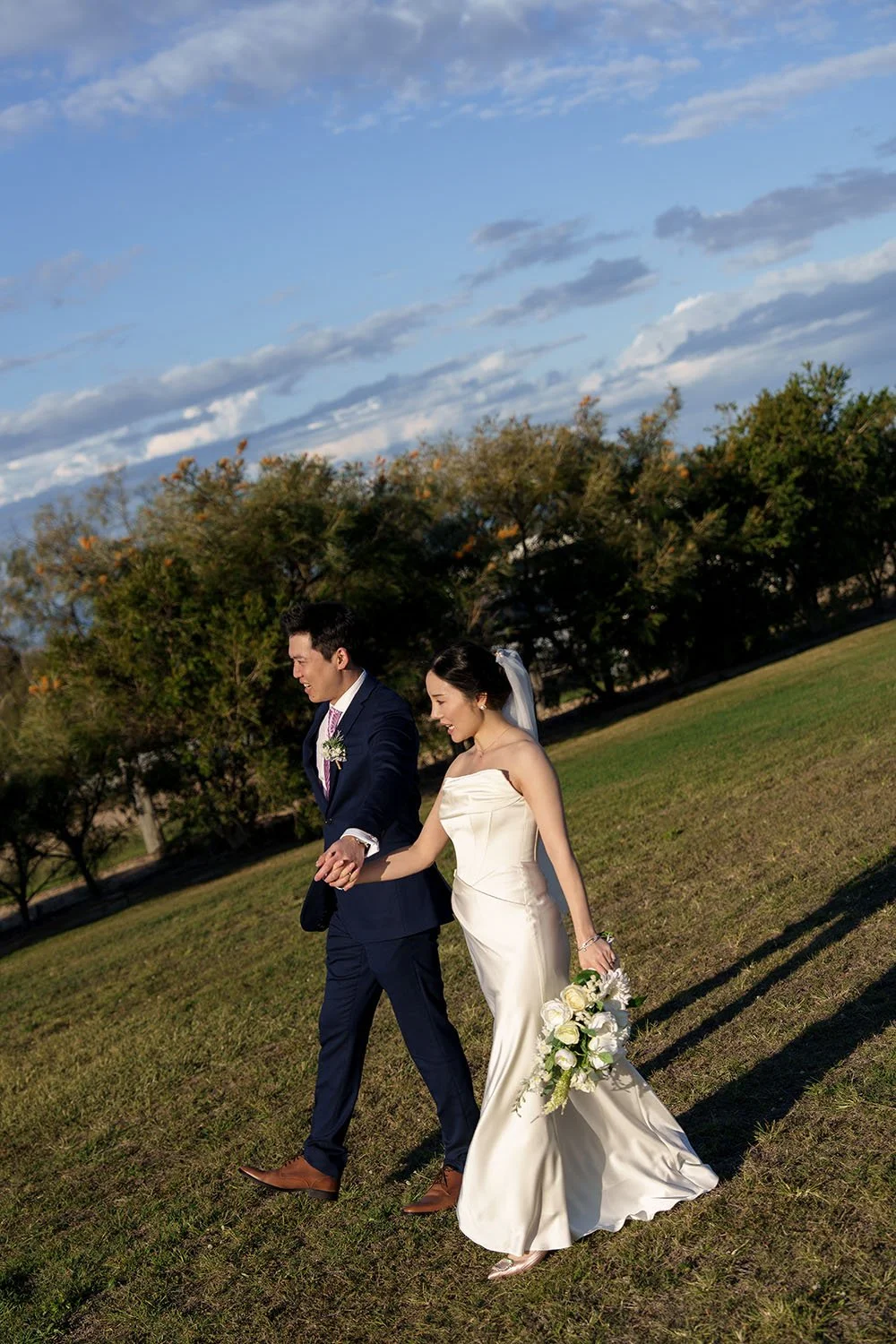 Eric and flora hold hands, swing your arms, and walk straight into the sun/light.