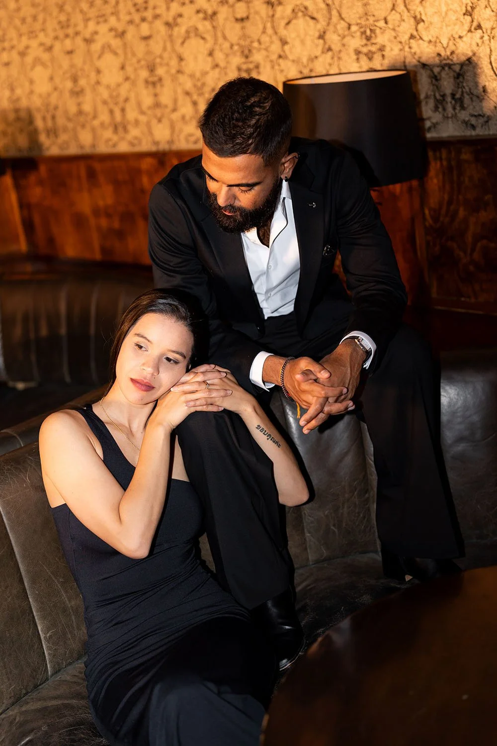 Jasmin holding Jay's knee while he look at her