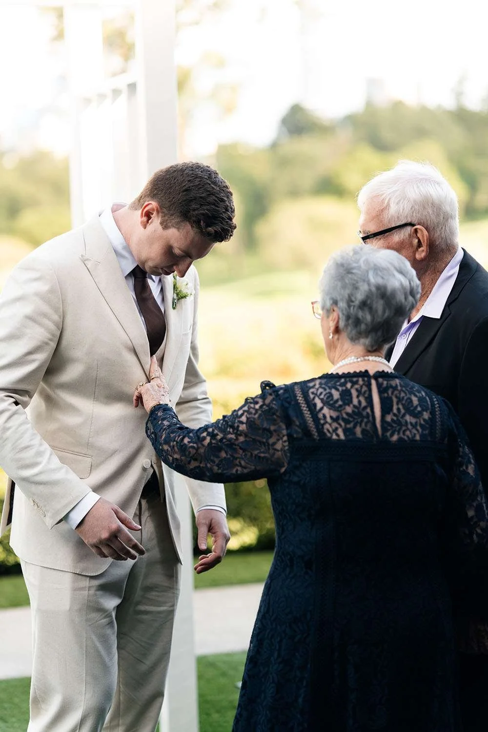 groom Jack's grandparents look at his suit and talk to him