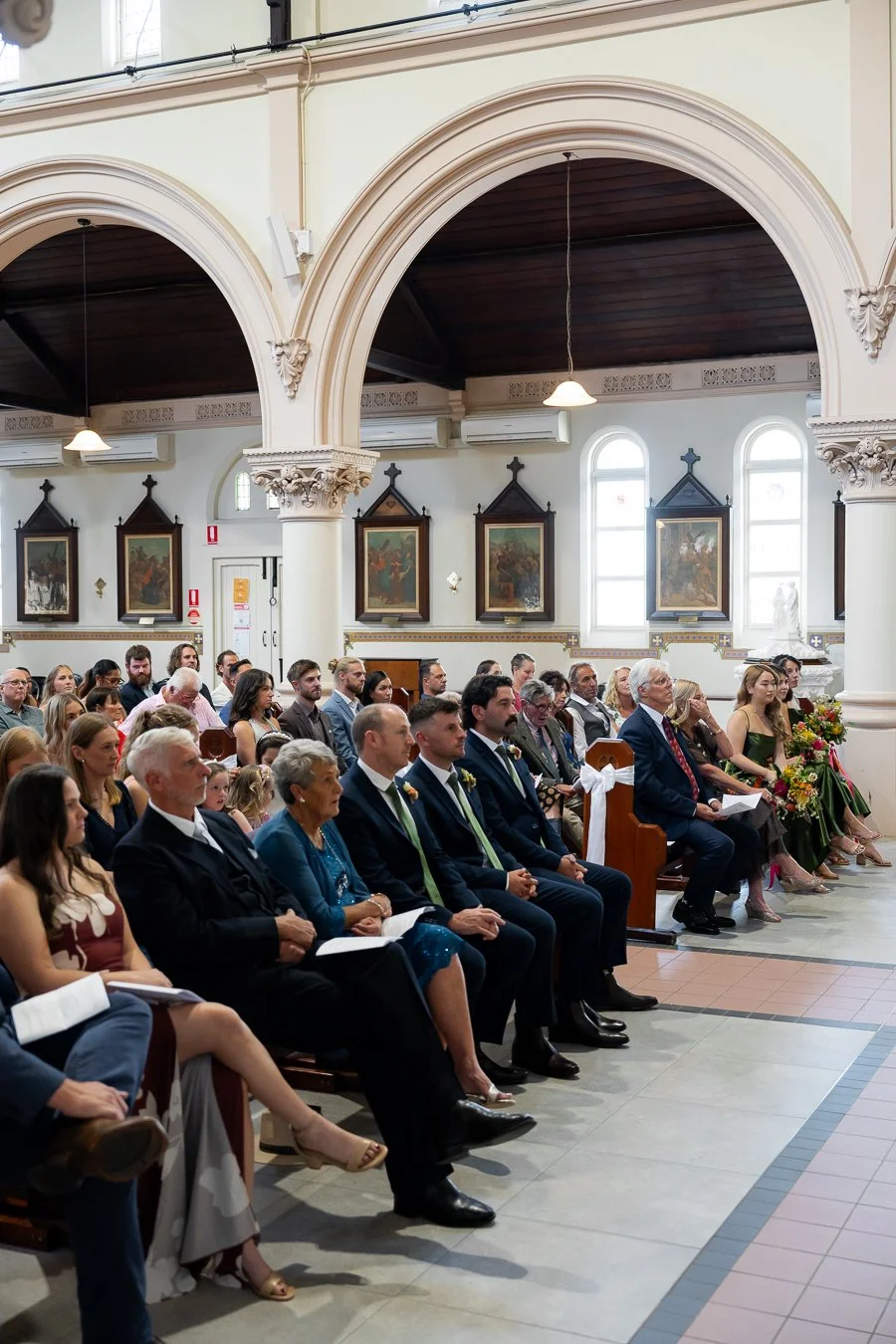 Their guests sat on benches, watching the wedding ceremony.