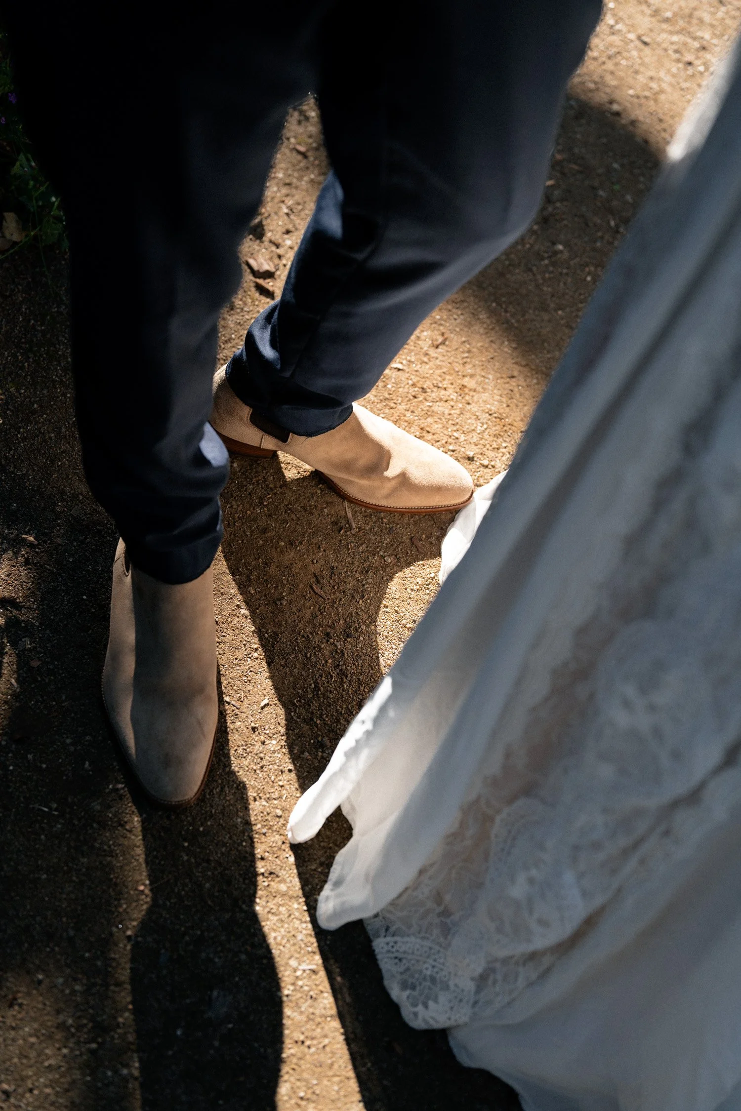 groom Leo's hoes and bride's dress under sunlight