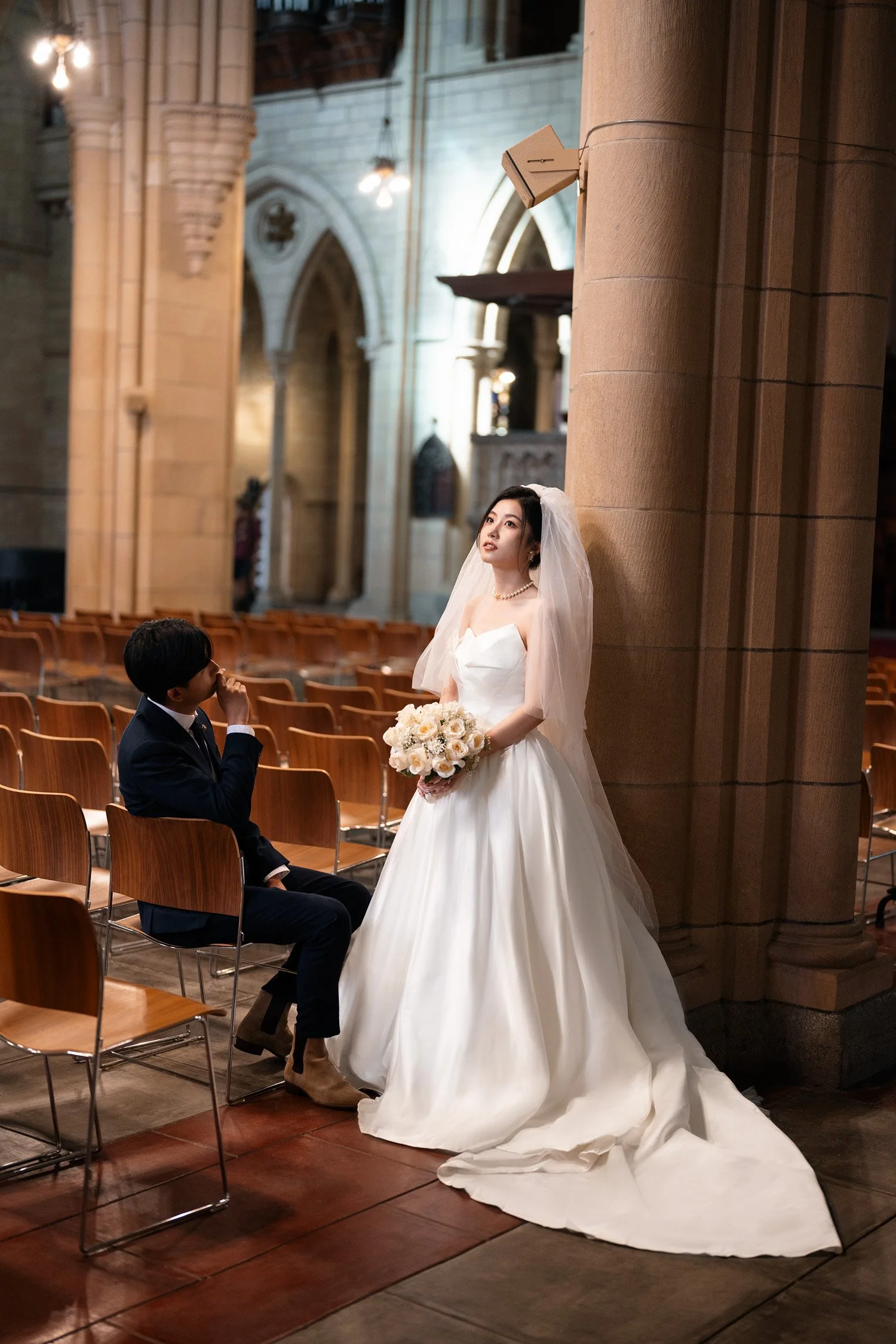 bride look up to the roof and groom look at her