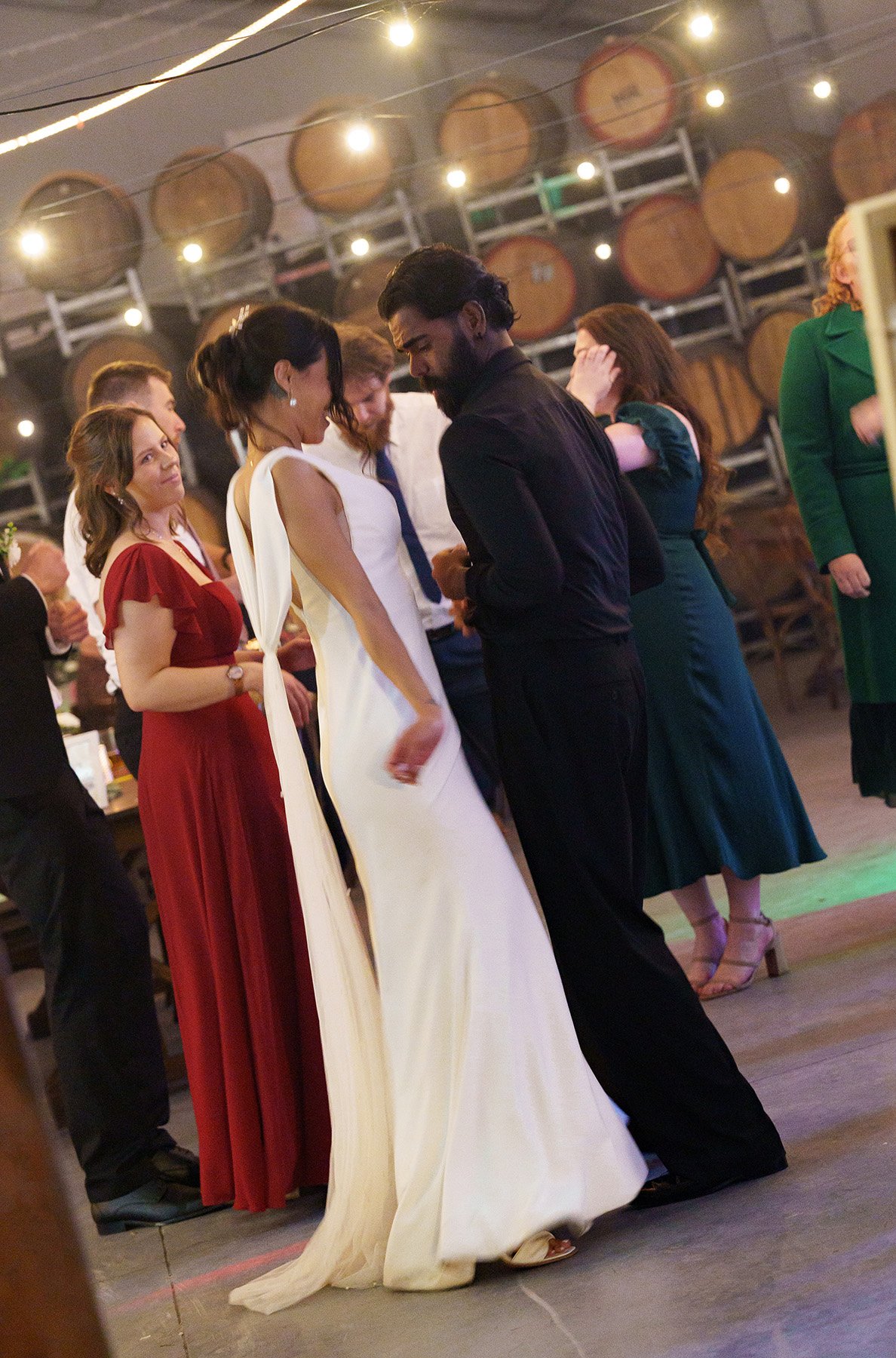 Jasmin and Jay dancing together, and maid of honour look at them with ow care eye, captured by Brisbane wedding photographer Whistler Li