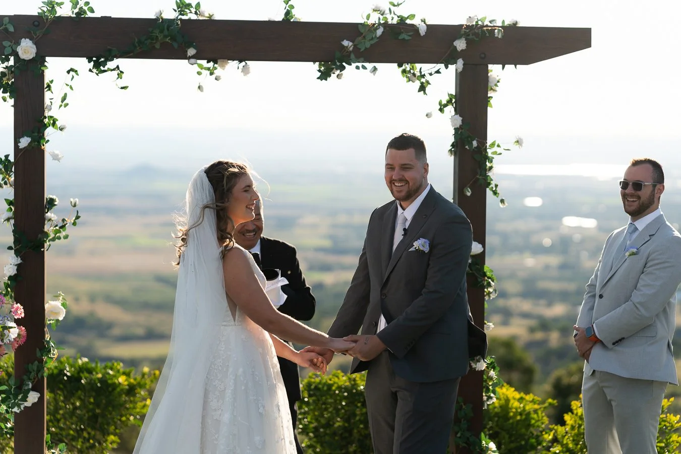 Ben and Chiarra hands holding and laughing to the guests