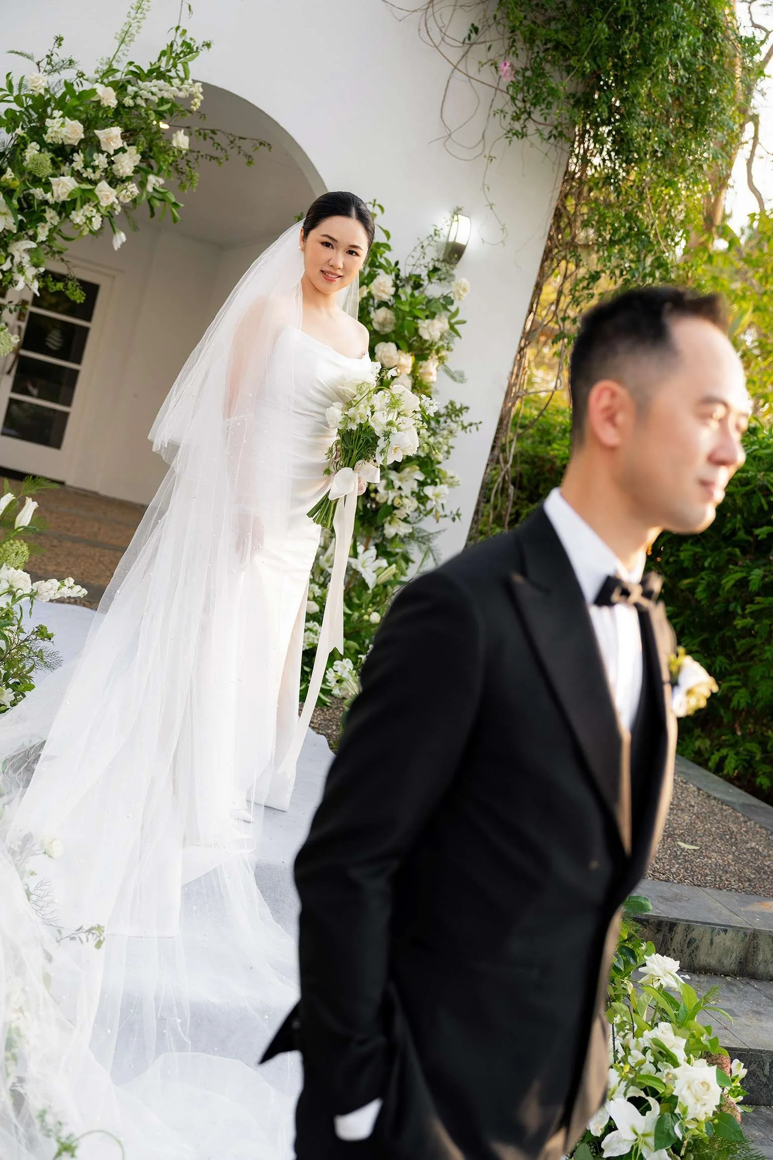 bride Wendy look at the camera, groom stand few away from her