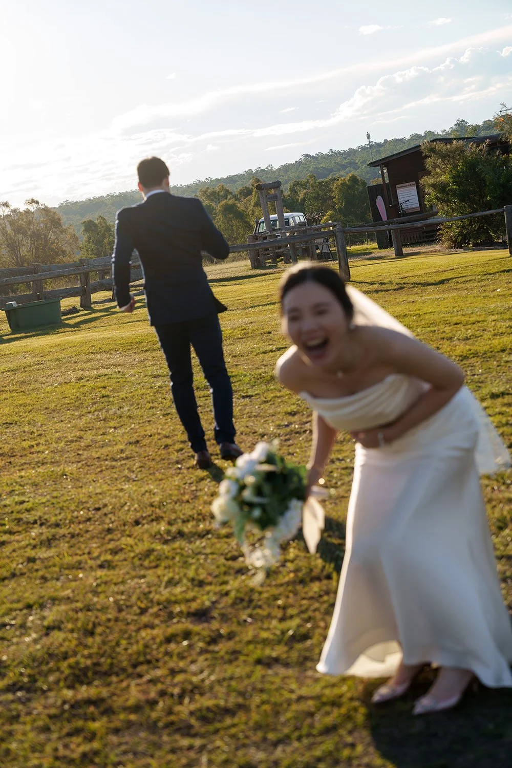 Flora laughing to the camera while Erice running away