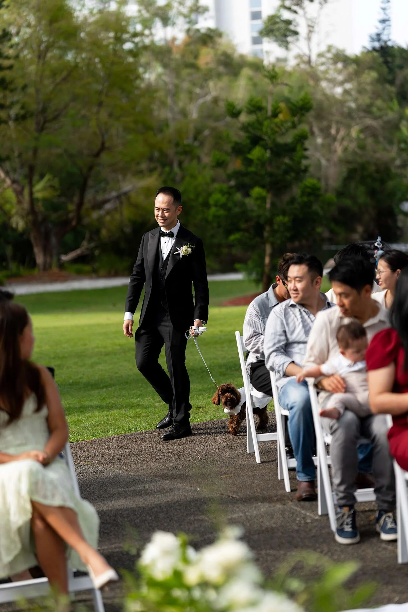 groom Alex walking into his wedding ceremony