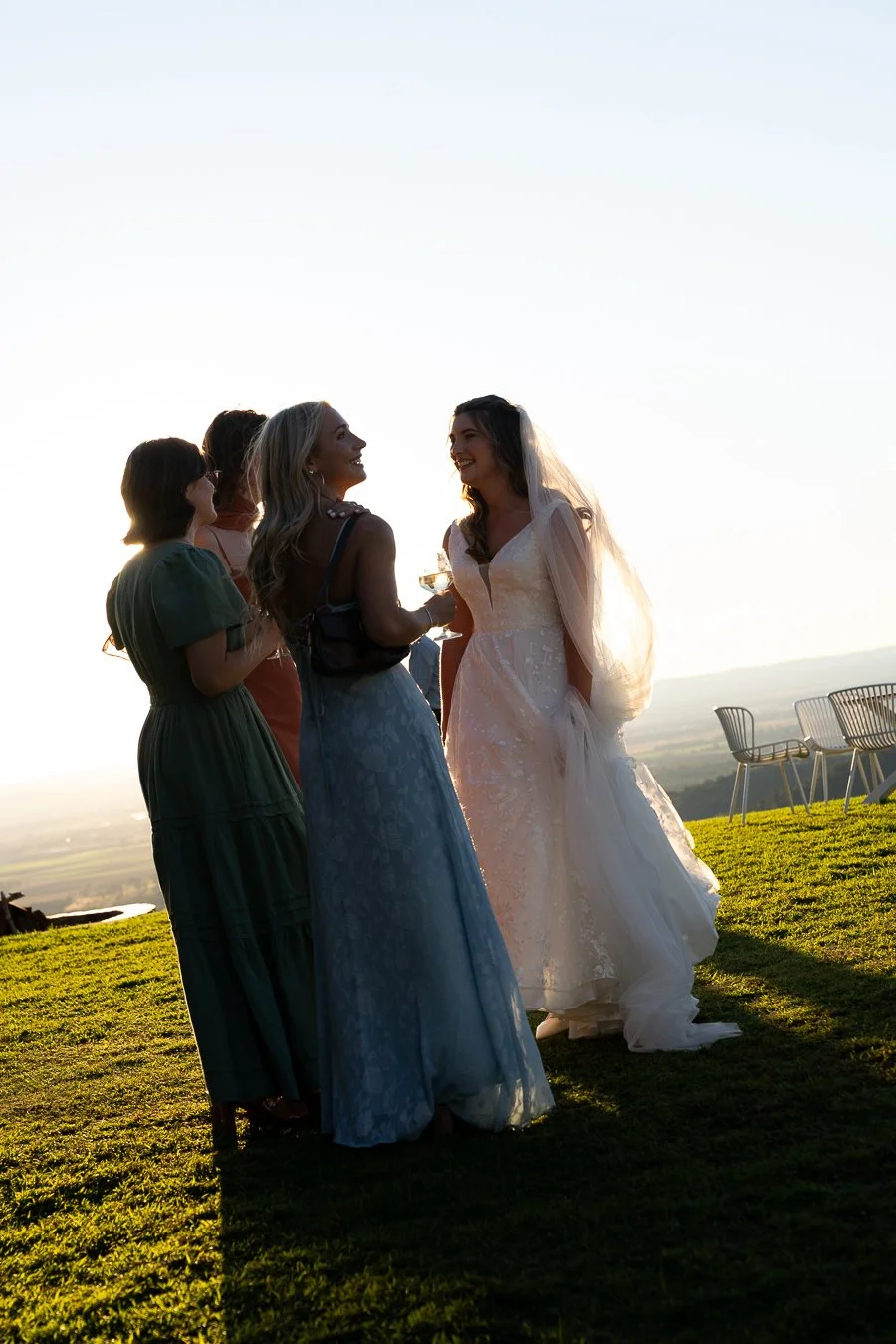 bride talking to 3 female with laughing 