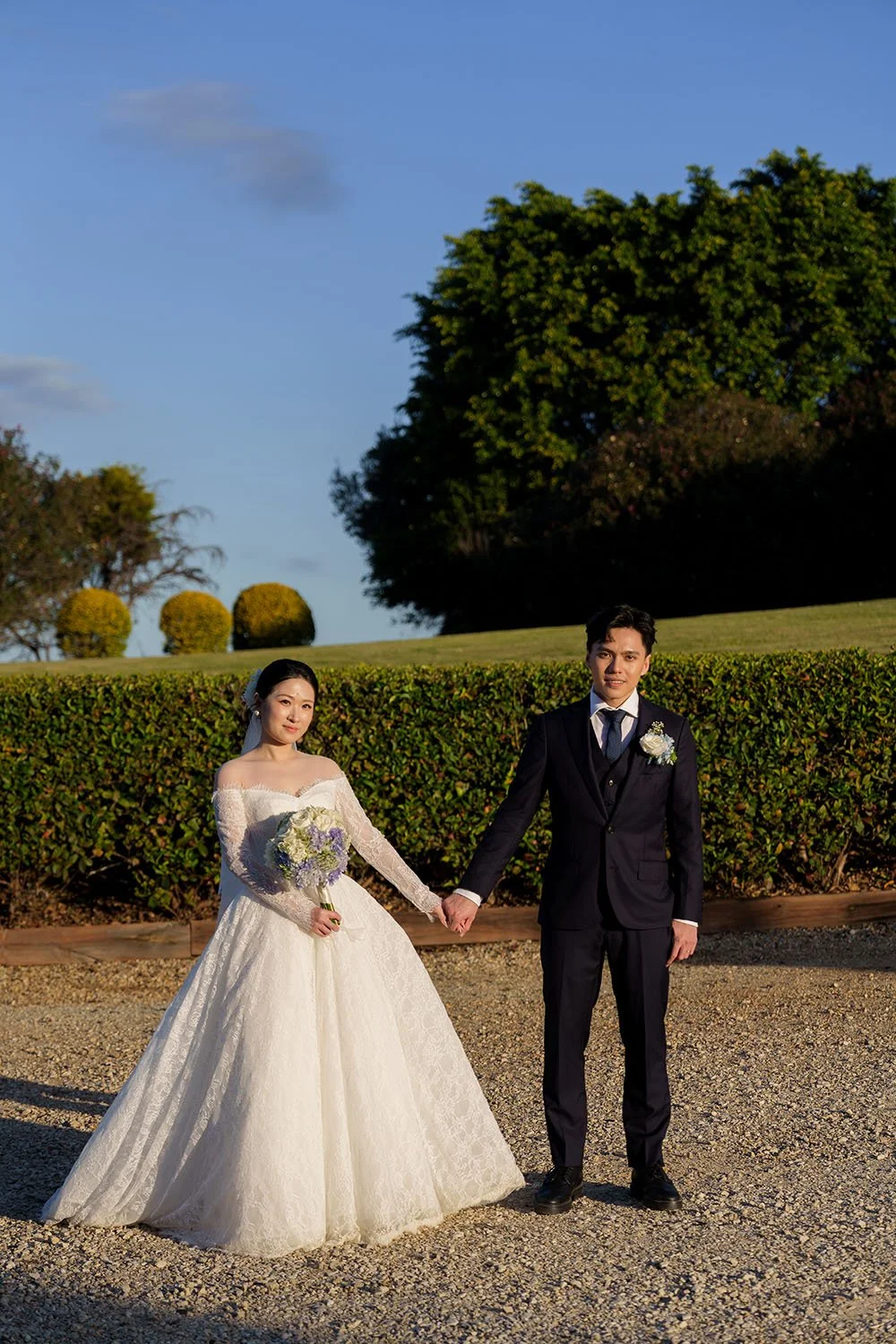 Michael and Lisa holding hands facing to the sun and look at the Brisbane wedding photographer Whistler Li