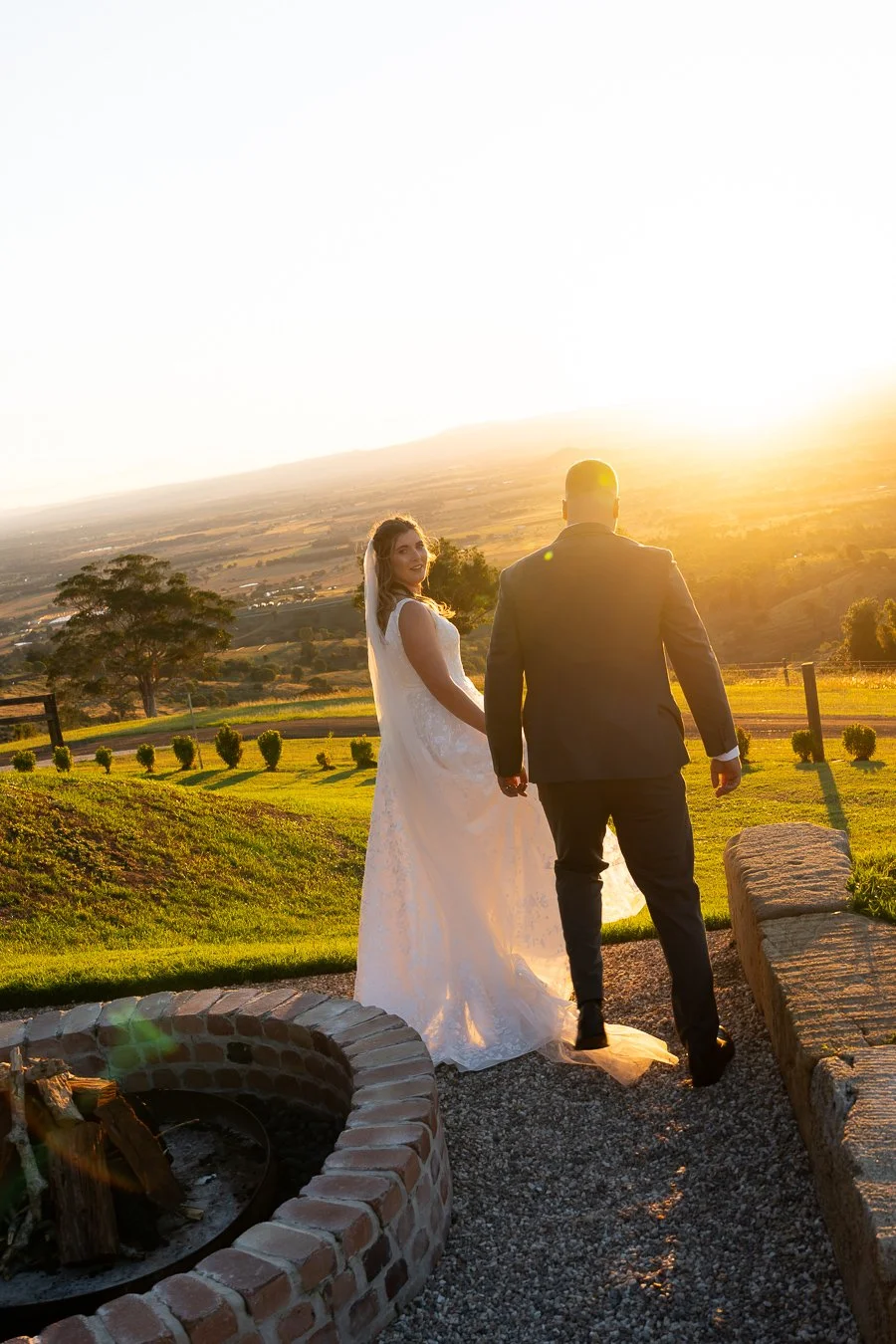 wedding photo and video packages, Chiarra look back to Whistler Li, and Ben walk away in beautiful mountain view golden hour