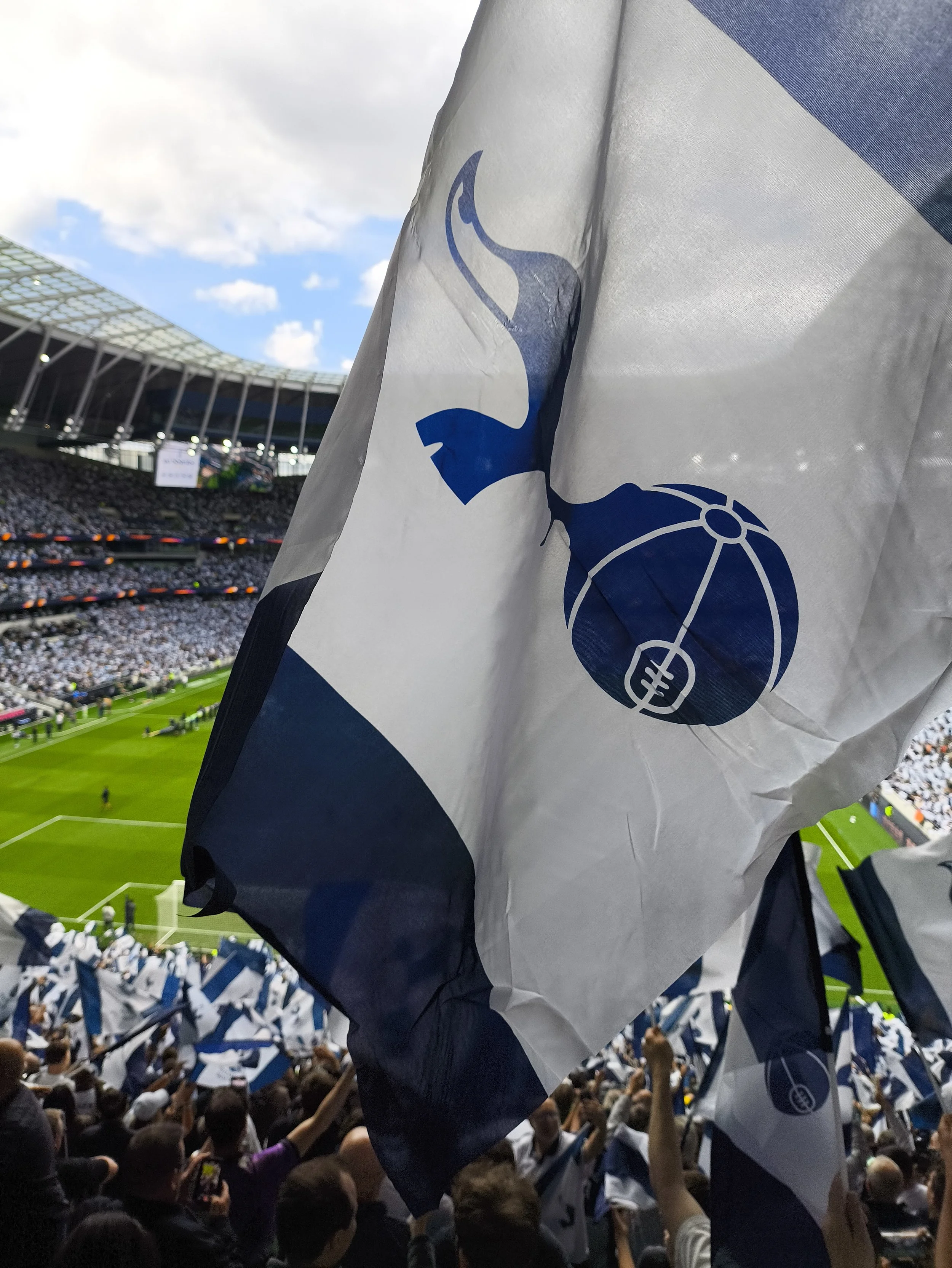 Photo taken by Simon Sloan of Racing Snake Media, showing a Tottenham flag being waved at a match day at the Tottenham Hotspur Stadium. Used as a Coming Soon image while we await the announcement of some exciting news about the Life Goals documentary