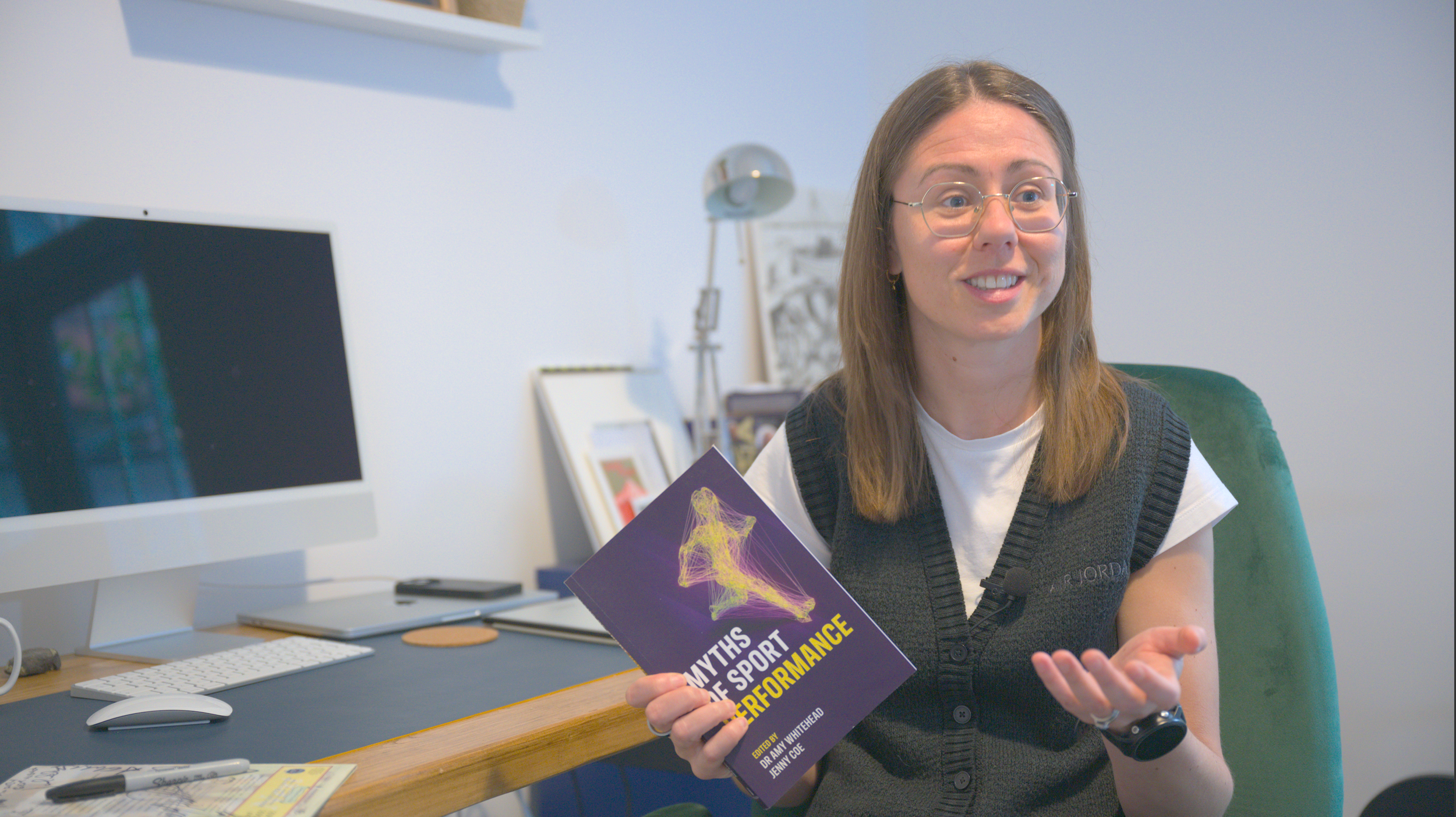 Professor of Sport Psychology at Liverpool John Moores University, Amy Whitehead, holding her book Myths of Sport Performance as she talks to Racing Snake Media for the Life Goals documentary.