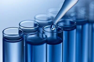 Close-up of test tubes and a pipette, indicating a laboratory setting