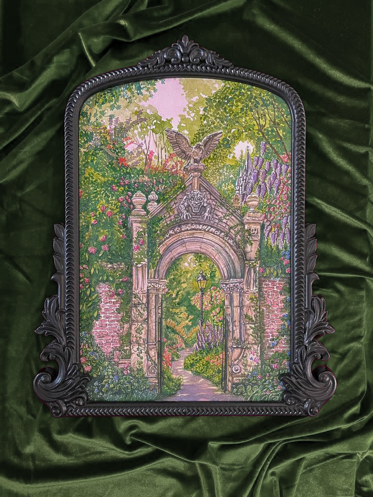 Decorative mirror with a black ornate frame reflecting a garden scene with a stone archway, flowering plants, and a pathway, on a green fabric background.
