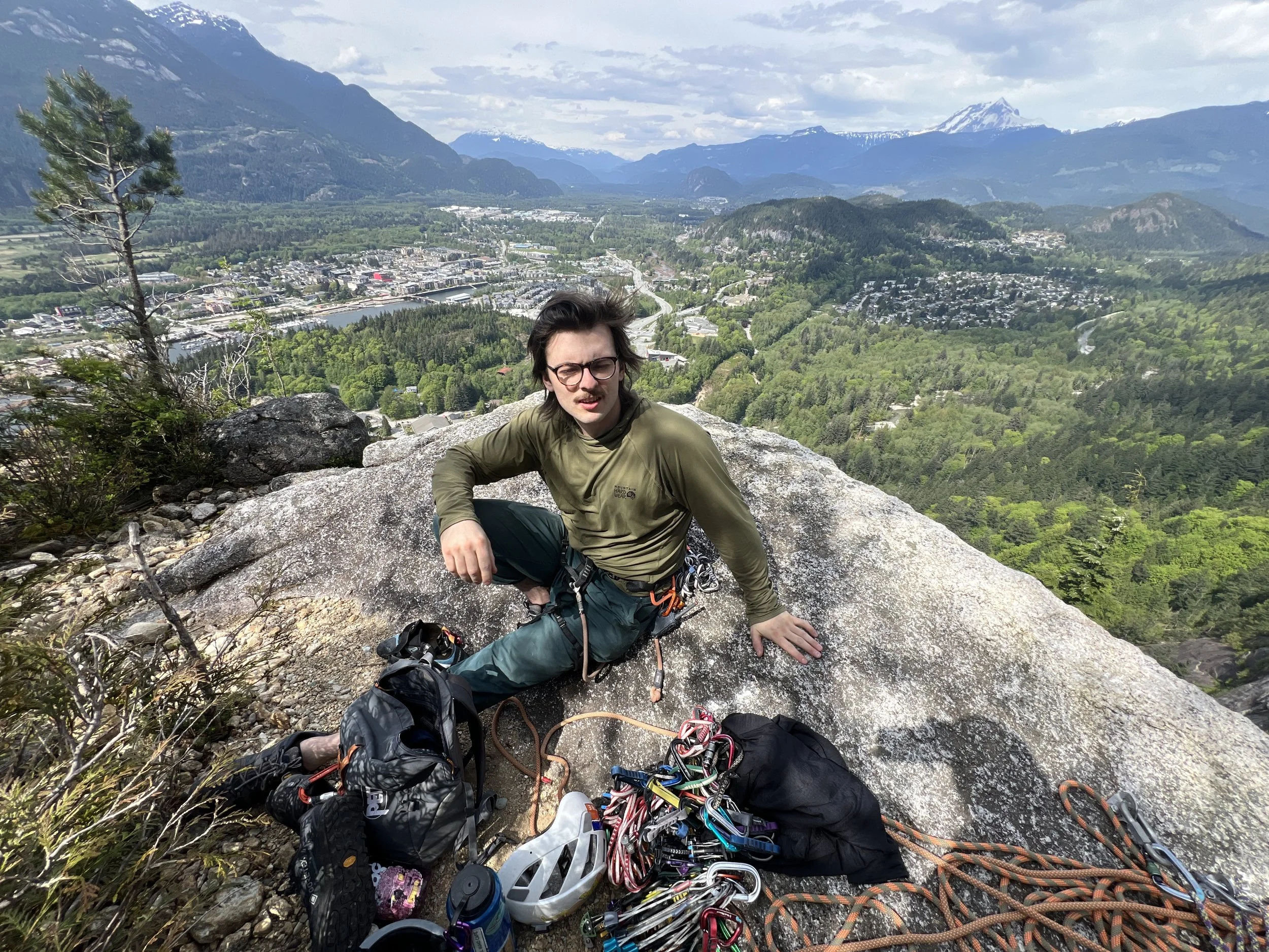 Joey sitting on the apron of the Chief in Squamish.