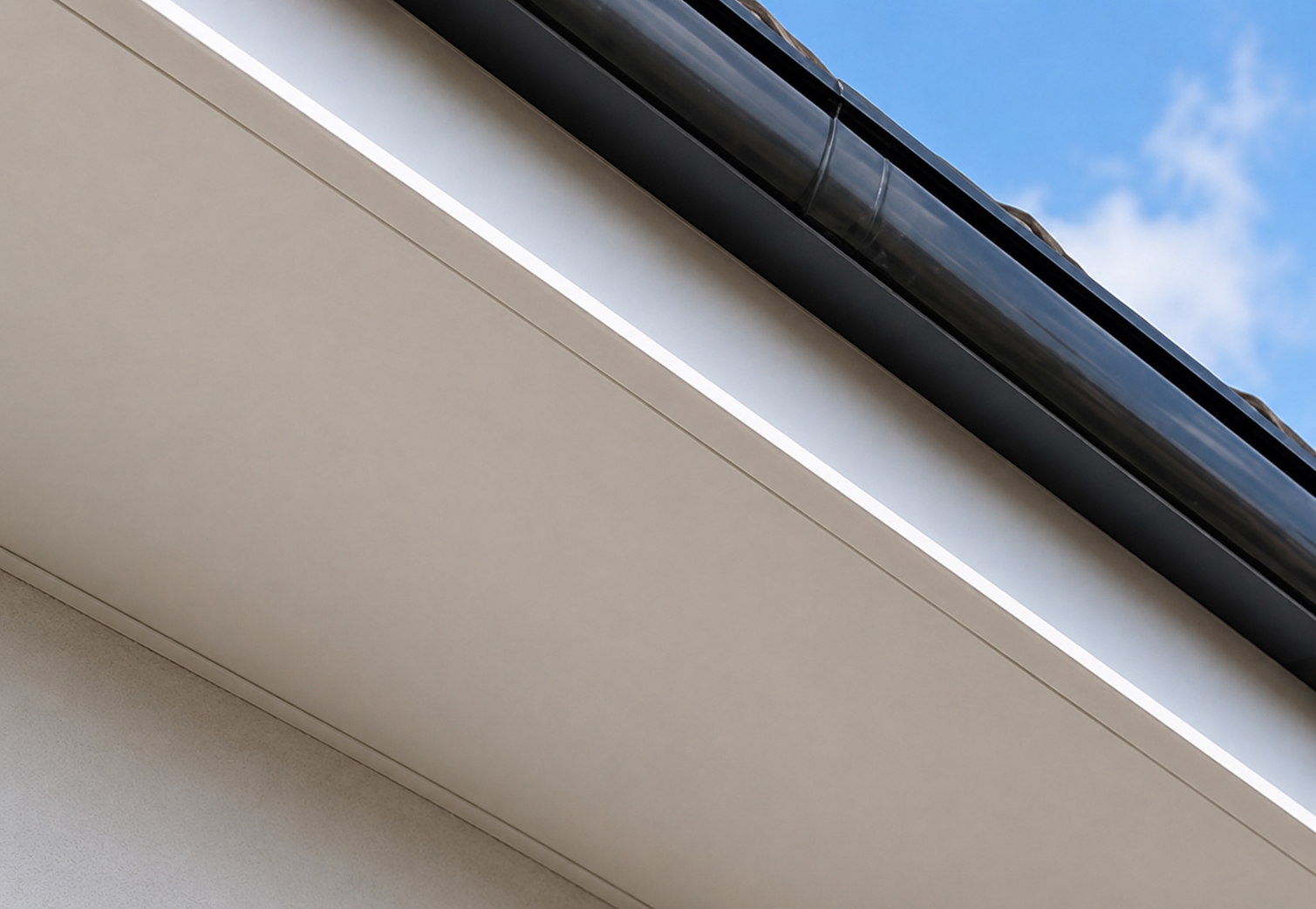 Close-up view of a modern building's exterior with clean lines and clear sky in the background.