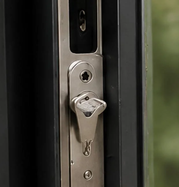 Close-up of a door lock with a silver latch and locking mechanism.