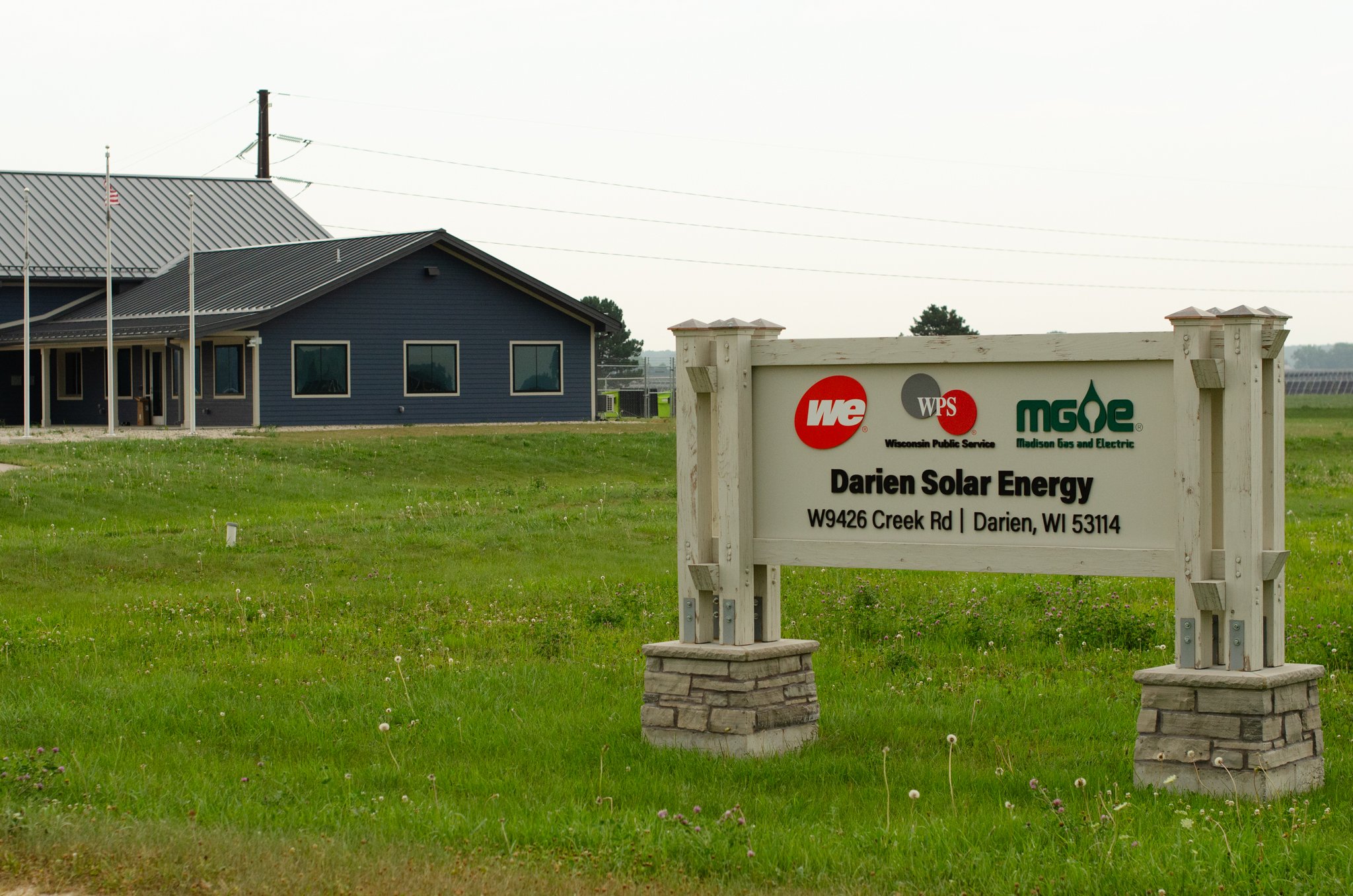 Darien Solar Energy entrance sign displaying the We Energies, Wisconsin Public Service, and Madison Gas and Electric logos.
