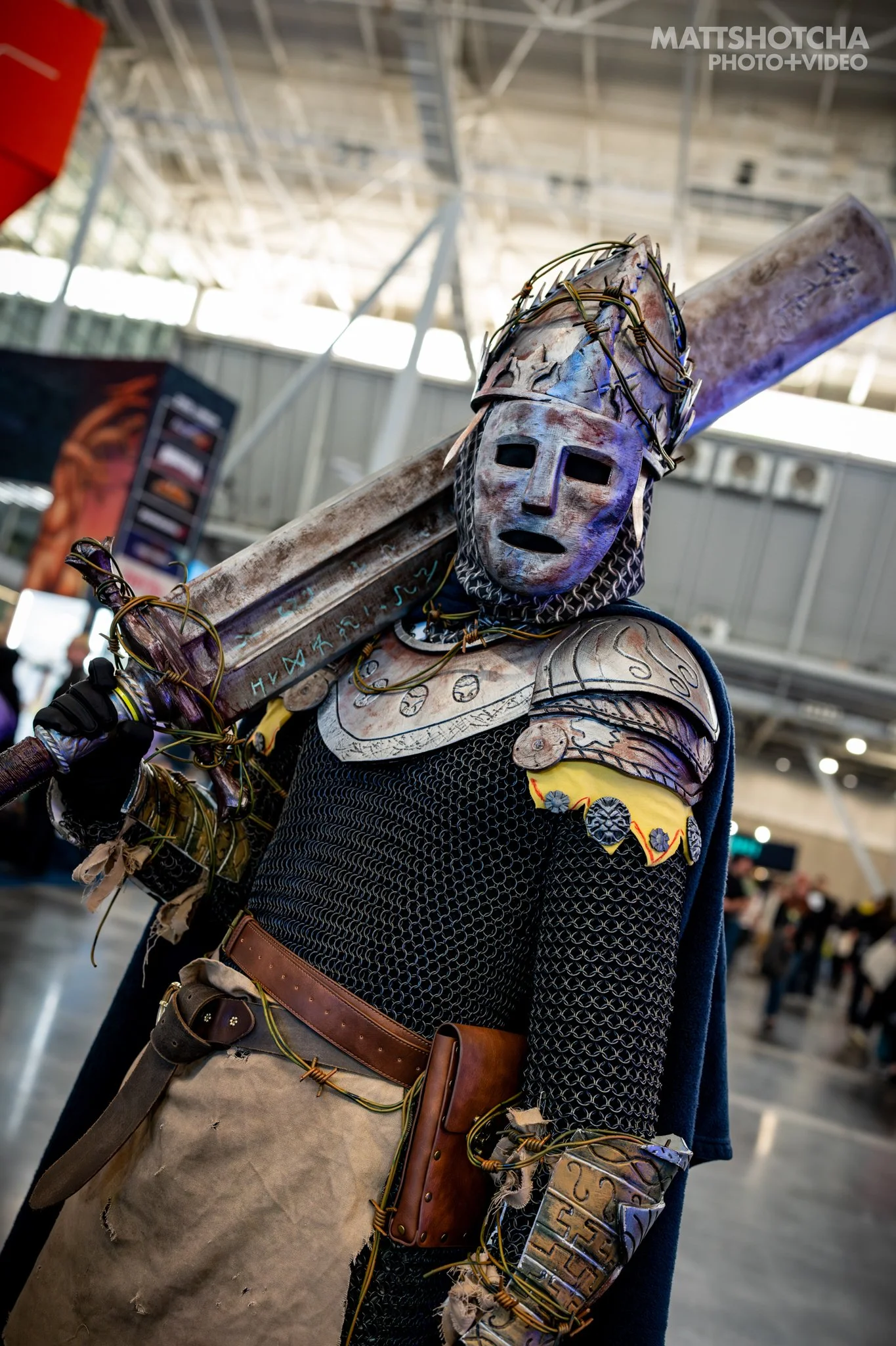 A man, CastleKing101, dressed as Elemer of the Briar from Elden Ring, in an elaborate costume resembling a medieval knight, carrying a large sword on their shoulder, at PAX East 2026.