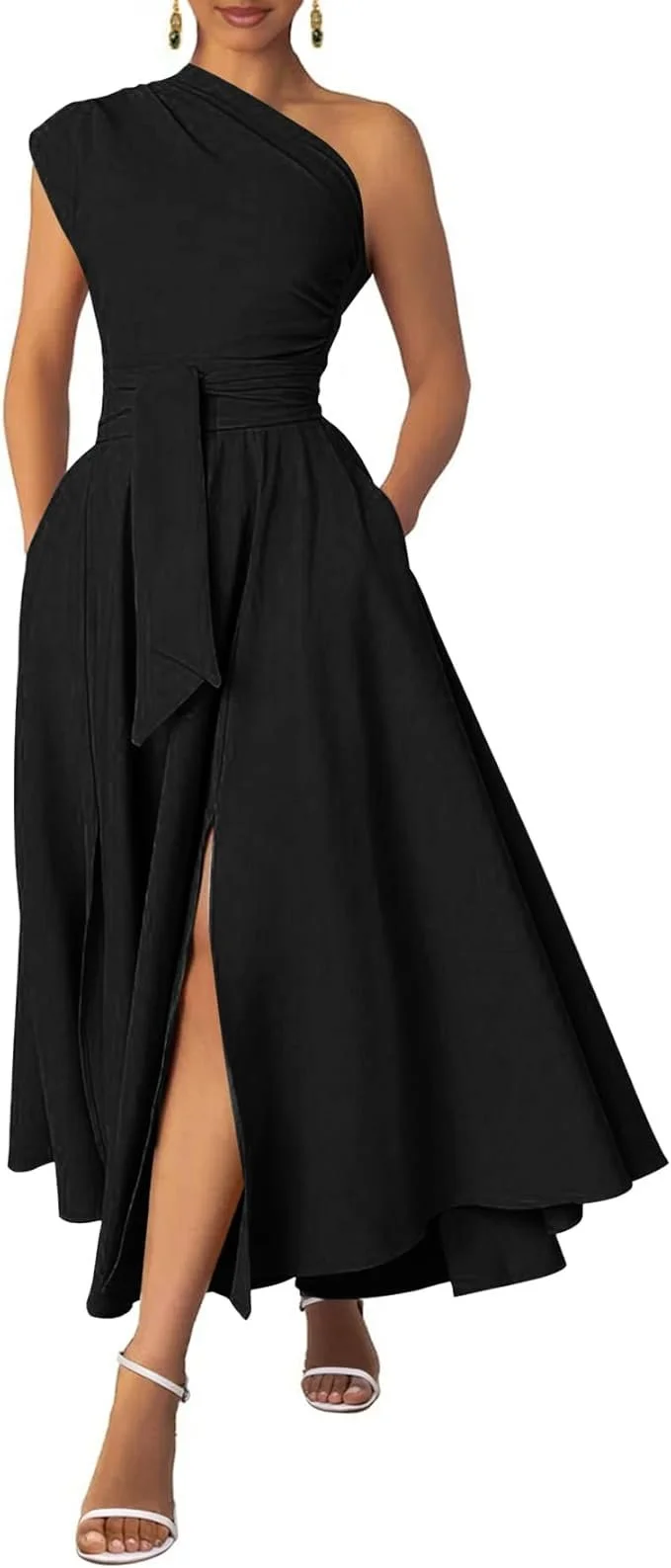 Woman wearing a one-shoulder black evening gown with slit and white high heel sandals.