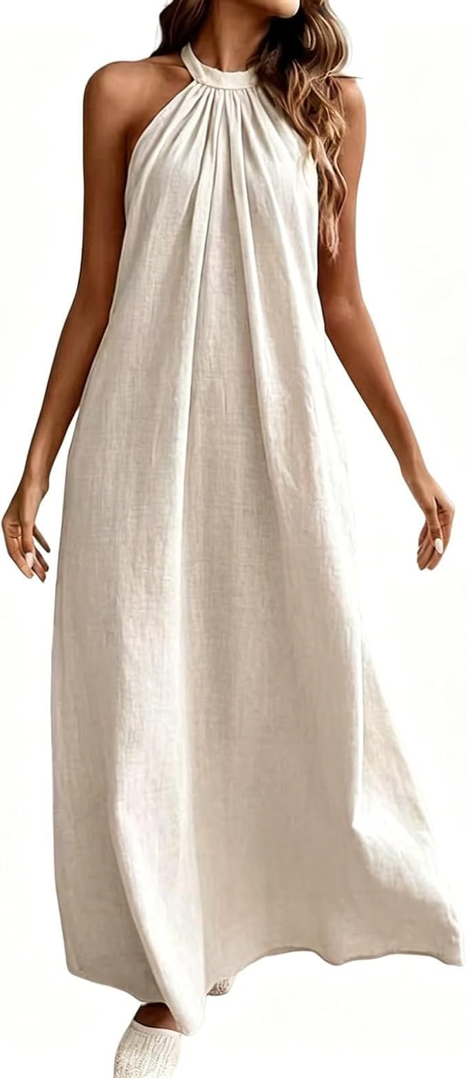 A woman wearing a sleeveless, high-neck, cream-colored maxi dress with pleated details at the top.
