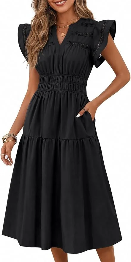 A woman in a black maxi dress with ruffled short sleeves, smocked waist, and a tiered skirt, wearing jewelry.