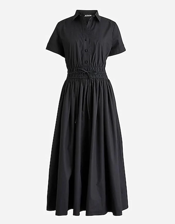Black short-sleeve shirt dress with a button-up front and a cinched waist, extending into a full-length skirt.