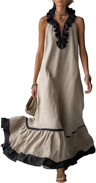 A woman wearing a sleeveless beige maxi dress with black ruffle accents and a ruffled hem, accessorized with layered necklaces, bracelets, and sandals, holding a clutch bag.
